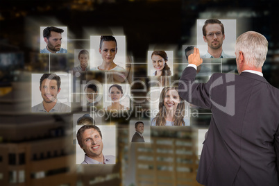 Composite image of rear view of stylish mature businessman pointing finger