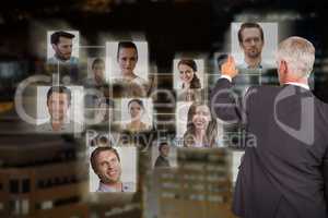 Composite image of rear view of stylish mature businessman pointing finger