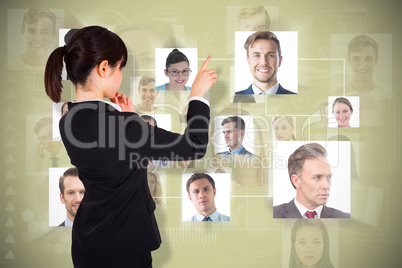 Composite image of thoughtful businesswoman pointing