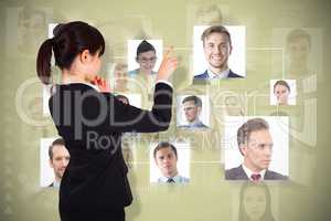 Composite image of thoughtful businesswoman pointing