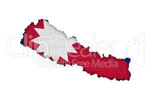Karte und Fahne von Nepal auf altem Leinen