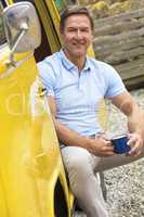 Handsome Middle Aged Man Drinking Tea coffee in Camper Van Bus