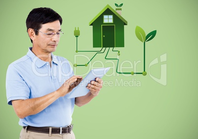 Man with tablet and green house graphic against green background