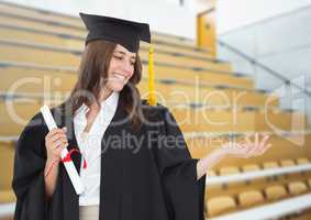Woman graduate with open palm hand in lecture theatre