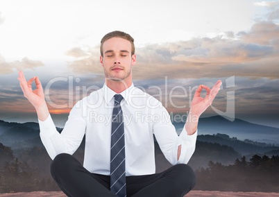 Man Meditating peacefully in mountains