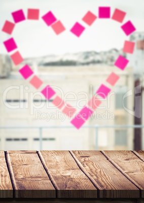 Wood table against window with heart sticky notes