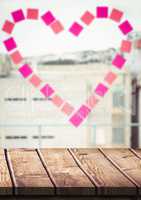 Wood table against window with heart sticky notes