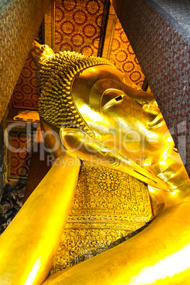 Reclining Buddha gold statue face. Wat Pho, Bangkok, Thailand
