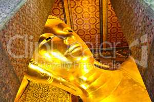 Reclining Buddha gold statue face. Wat Pho, Bangkok, Thailand