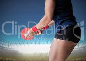 Table tennis player lower body against stadium with bright lights and blue sky