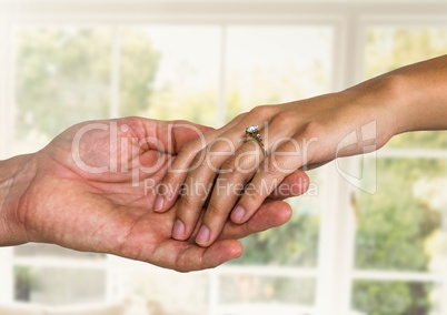 Wedding engaged couple holding hands by window