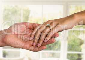 Wedding engaged couple holding hands by window