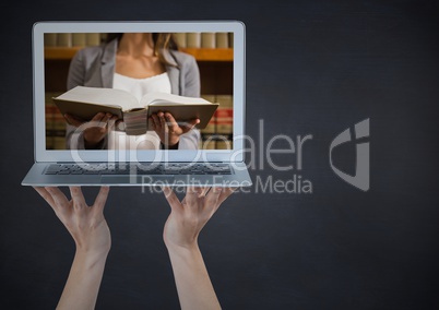 Hands with laptop showing woman reading against chalkboard