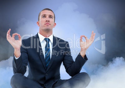 Businessman Meditating with clouds