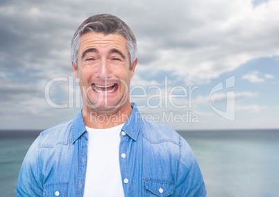 Man crying against sea