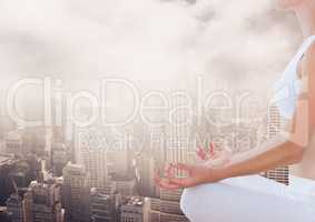 Woman Meditating peaceful over city