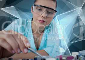 Woman with electronics against blue geometric background