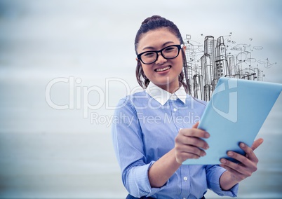 Woman with tablet and sketch of buildings against blurry grey wood panel