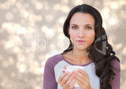 Woman staring straight ahead with white mug against cream bokeh