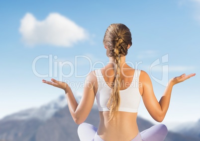 Woman Meditating by mountains