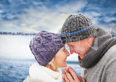 Elderly couple against blurry field with snow