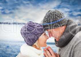 Elderly couple against blurry field with snow