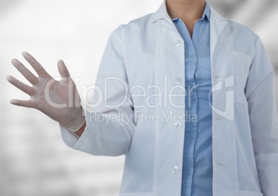 Doctor mid section with hand out at side against blurry background