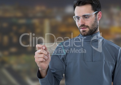 Man with glass tablet against Night city