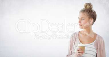 Woman looking to the side coffee cup against white wall