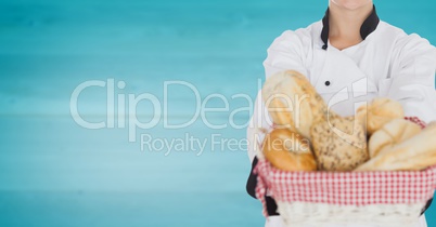 Chef with bread against blurry blue wood panel
