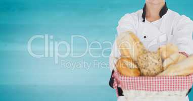 Chef with bread against blurry blue wood panel