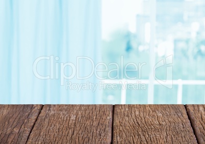 Wood table against blurry blue window