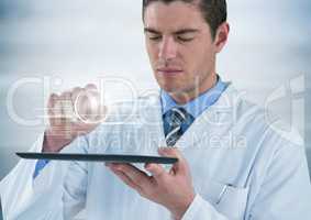 Man in lab coat with tablet and white interface with flare against grey background