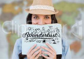 Woman reading with black wanderlust doodles against blurry map