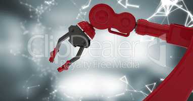 Red robot claw with white interface against blurry grey room