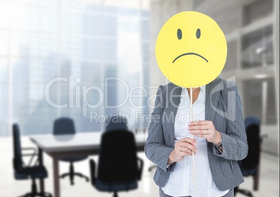 Sad businesswoman against office meeting room