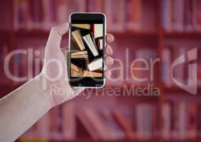 Hand with phone showing standing books against blurry bookshelf with red overlay