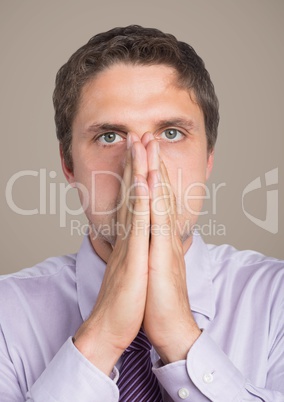 Man in lavender with hands over mouth against brown background