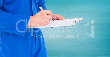 Mechanic with clipboard against blurry blue wood panel