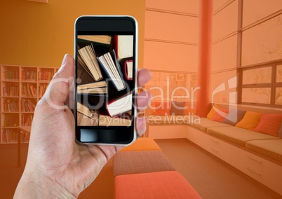 Hand with phone showing standing books against room with orange overlay