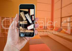 Hand with phone showing standing books against room with orange overlay
