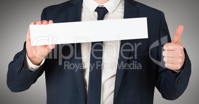 Business man torso with blank card ahd thumbs up against grey background