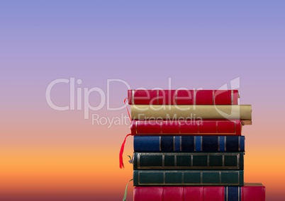 Books stacked by twilight sky