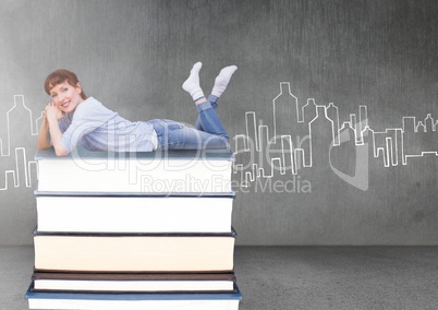 Woman lying on Books stacked by city drawing