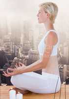 Woman Meditating peaceful over city
