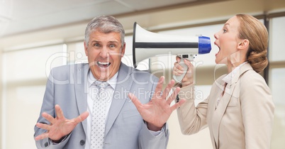 Women shouting at Stressed businessman in office