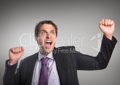 Business man fists in air against grey background