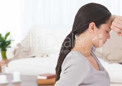 Sad woman leaning on wall at home