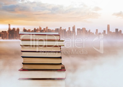 Books stacked by distant city