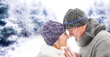 Elderly couple in snowy landscape with flare